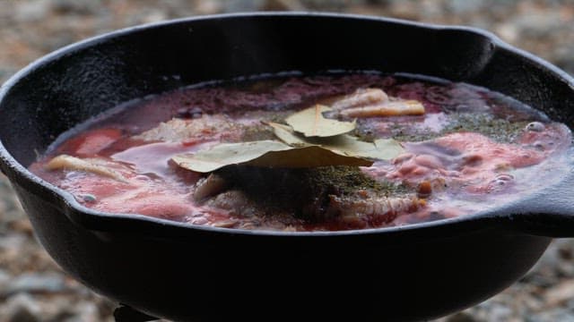 Stir-fried vegetables added to the chicken dish in frying pan