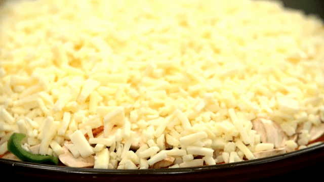 Cheese covered pizza dough