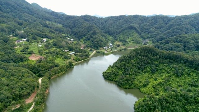 Lake Surrounded by High Mountains and Land