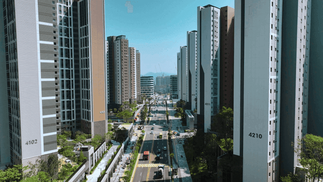 Bustling city streets between tall apartment complexes