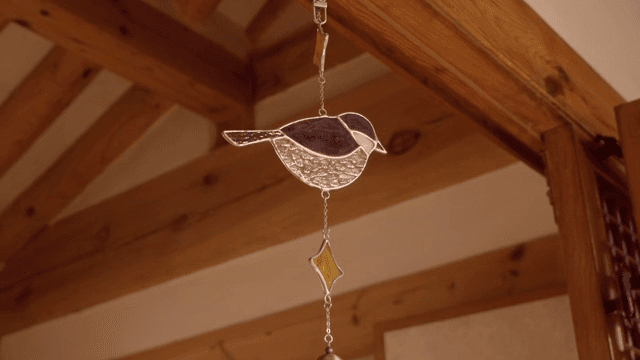 Decorative glass bird hanging indoors