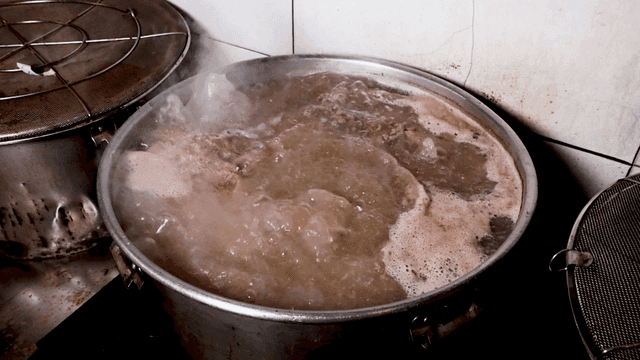 Meat broth boiling in large pot