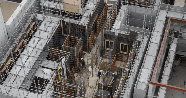 Construction site with workers and scaffolding