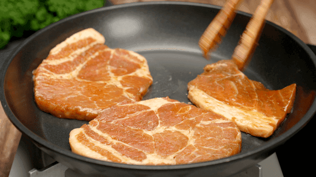 Marinated pork slices cooking in a pan