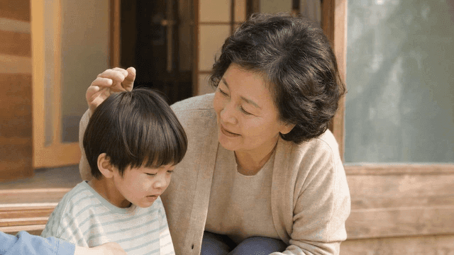 Elderly woman comforting sad child