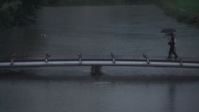 People walking with an umbrella on a rainy day