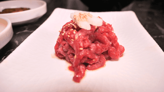 Red raw meat on white plate