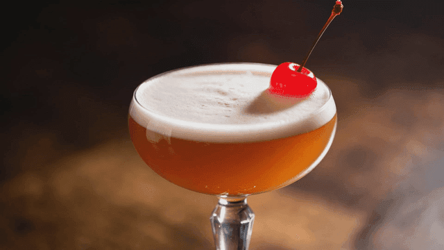 Cocktail with cherry garnish