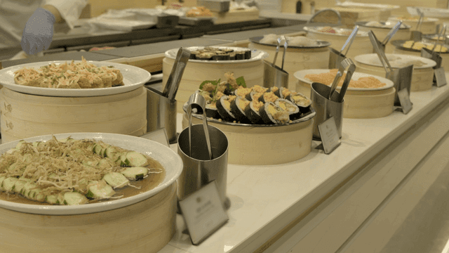 Variety of kimbap and sushi dishes on buffet table