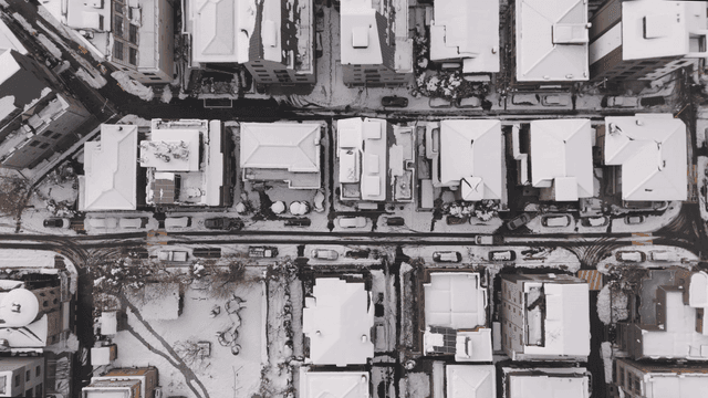 Snow-covered city buildings from above