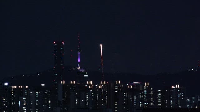 Fireworks over a city skyline at night