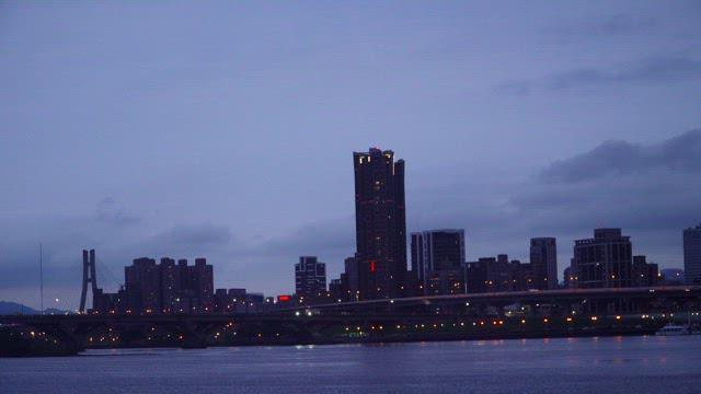 Dark Twilight Cityscape with Buildings and Bridge