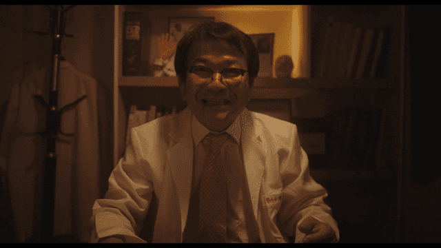 Doctor smiling while explaining in dark office
