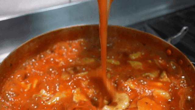 Spicy handmade dumplings boiling in pot