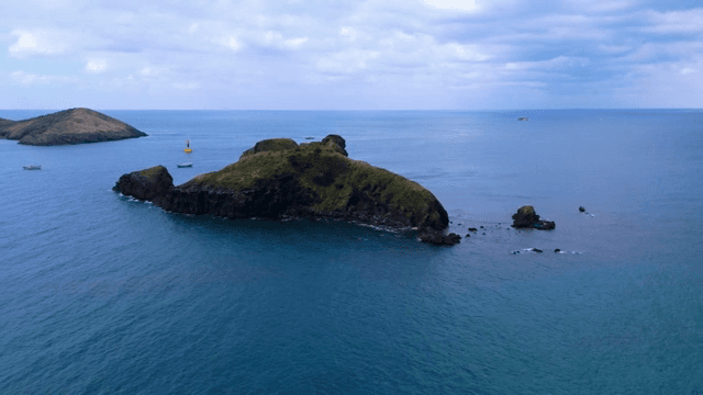 Small island surrounded by blue sea