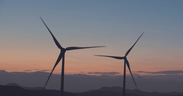 Wind turbines in the mountain at sunset