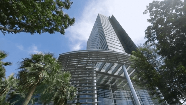 Modern skyscraper surrounded by trees