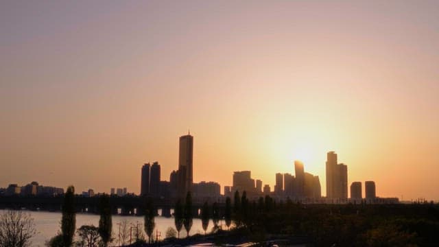 Sunset Over The City Skyline By The River