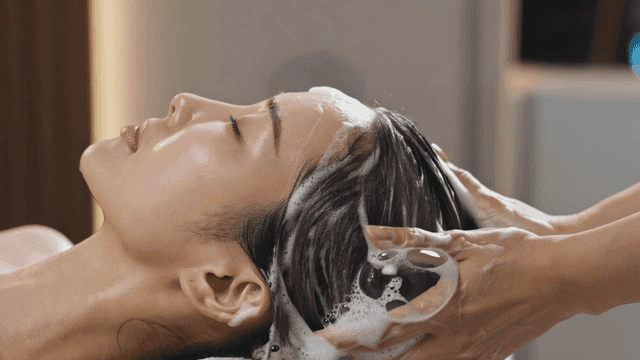 Woman having her hair washed comfortably