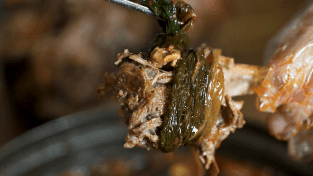 Gamjatang, eaten by wrapping dried radish greens around pork backbones.