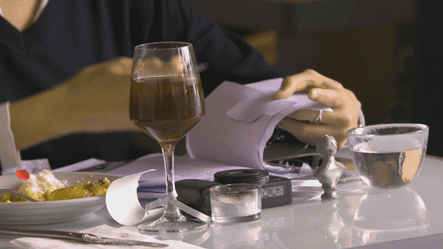 Person reviewing documents at dining table