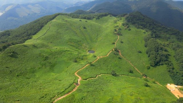 Green mountains with small lakes in sunken terrain