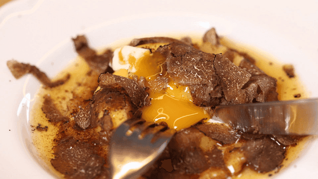 Ravioli topped with truffles and runny egg yolks