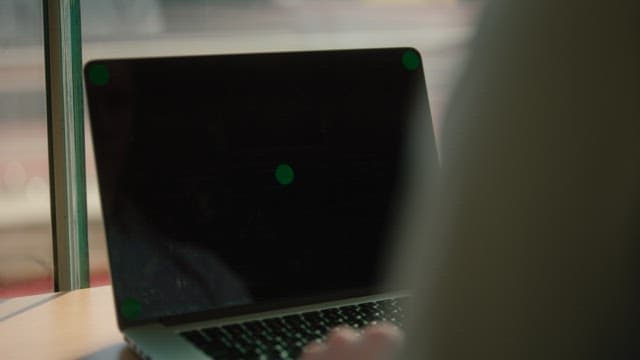 Person working on laptop beside the window