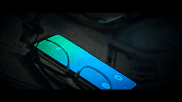 Glasses and ringing smartphone on newspaper