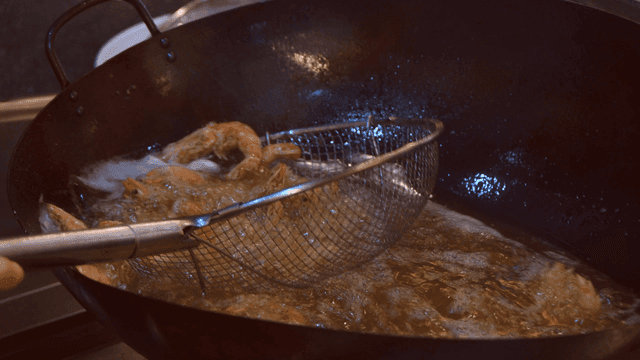 Fried shrimp fried in oil in hot wok