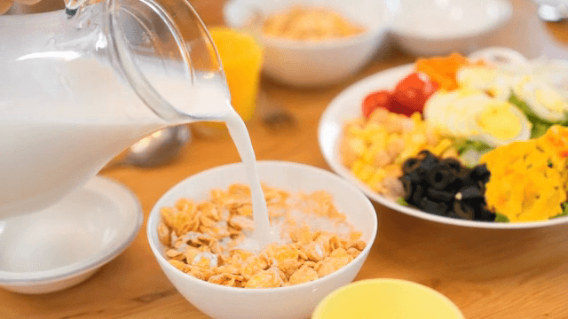 Breakfast table with cereal and salad