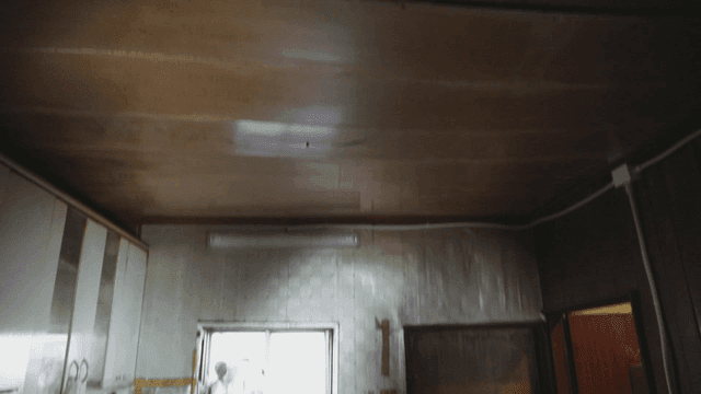 Neglected house kitchen with a wooden ceiling that looks like it could collapse