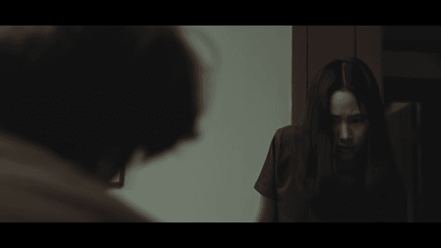 Two people facing each other in the living room