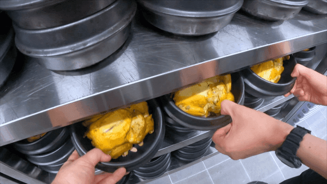 Boiled chickens placed in numerous earthen pots