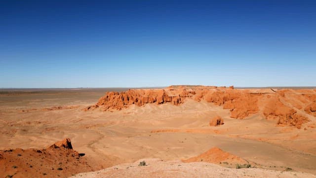 Vast desert landscape with red cliffs