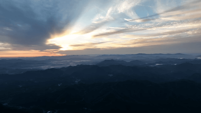 Sunrise over a vast mountain range