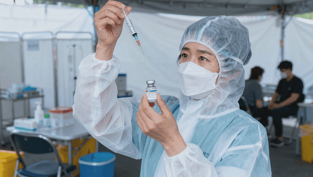 Preparing vaccination at temporary clinic medical staff