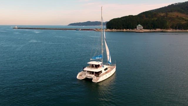 Catamaran Sailing on Serene Sea at Dusk