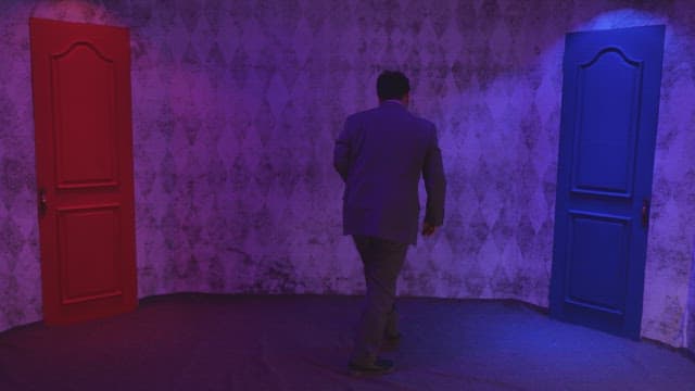 Man in a suit choosing between two doors