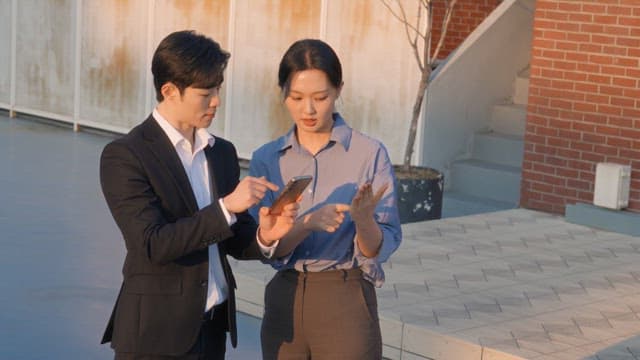 Two colleagues discussing work on a rooftop