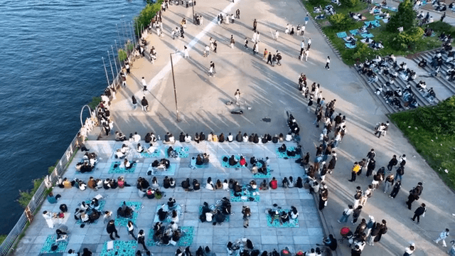 People watching busking on the riverside