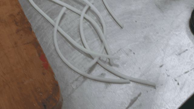 White silicone strand lying on workbench
