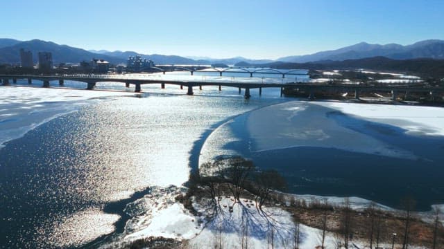 Winter Landscape with Bridge over Frozen River