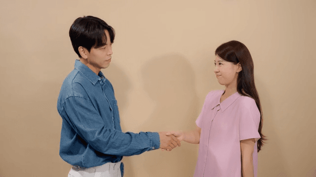 Man and a woman comforting each other by shaking hands in reconciliation