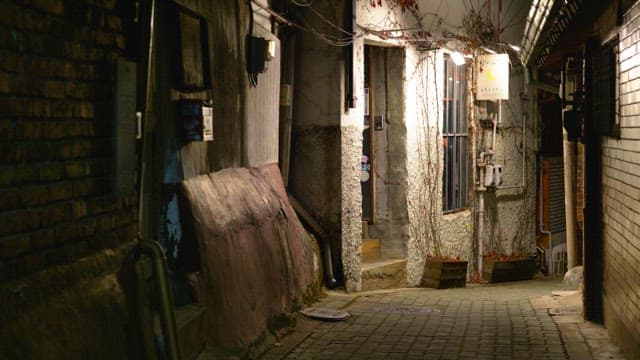 Residential alley at night with dim lights