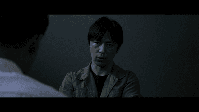 Man interrogating in dark room