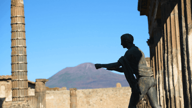 Ancient statue with mountain backdrop