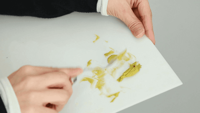 Hand mixing paint with knife on palette