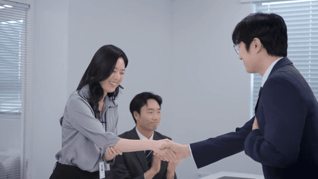 A meeting scene where the signed contract is handed over