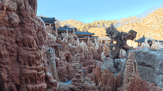 Traditional Korean architecture amidst rocky formations